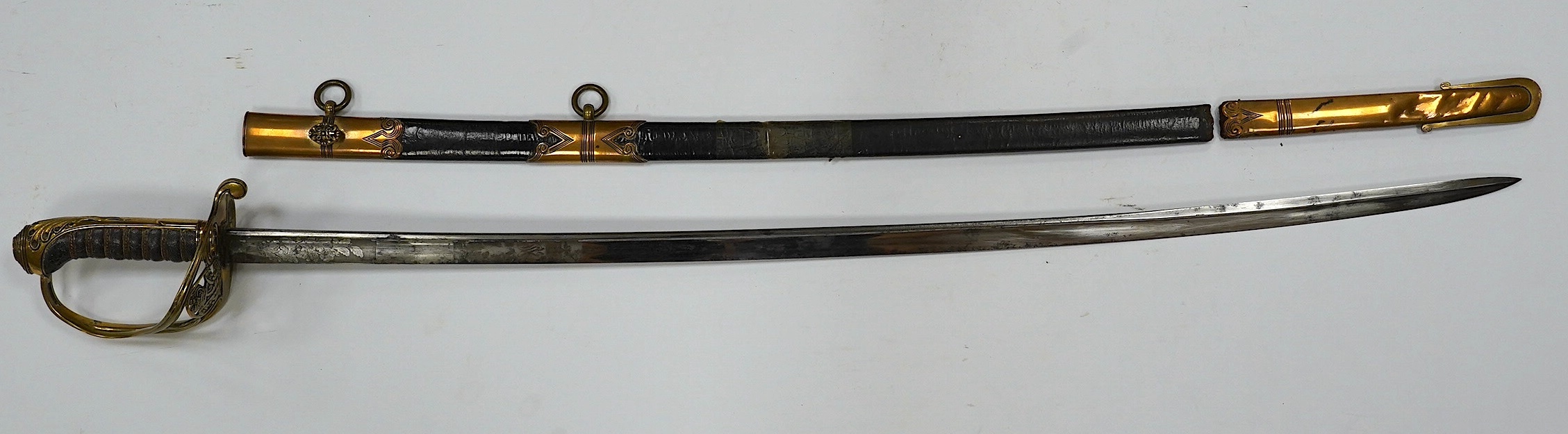 An early 19th century officer's sword, William IV cypher to knuckle guard, folding knuckle guard, engraved curved blade with William IV cypher and makers signature; ‘Vernon 4 Charing Cross London’, leather scabbard with
